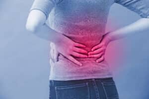 Woman holding her back in pain from a herniated disc